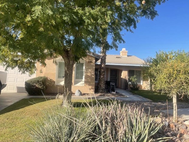 view of front facade with a garage and a front yard