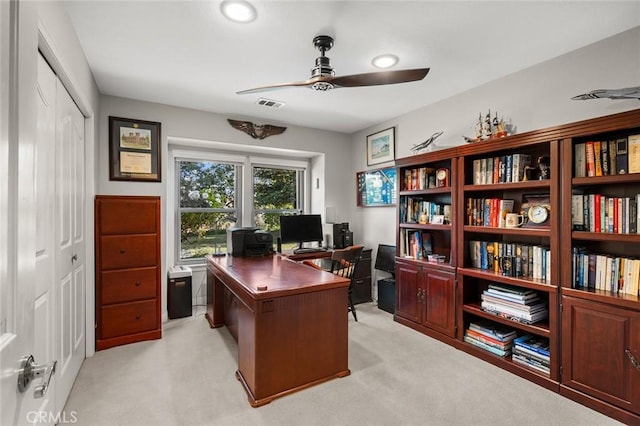 carpeted office space with ceiling fan