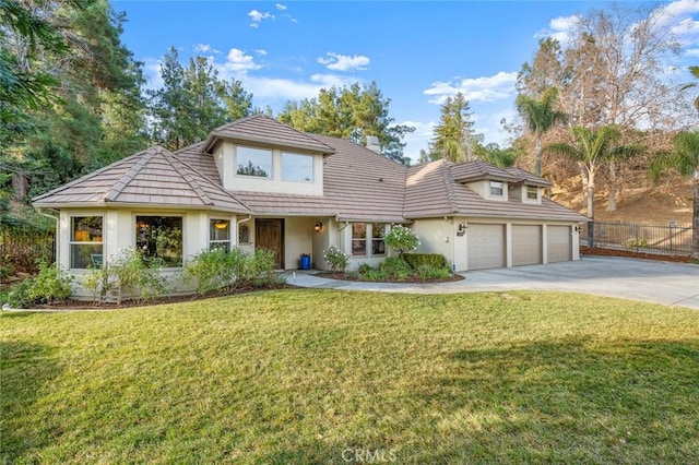 view of front property with a garage and a front lawn