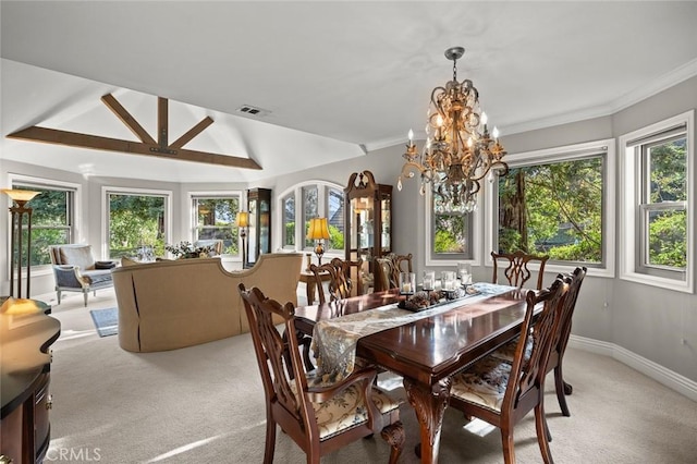 carpeted dining space featuring lofted ceiling, a chandelier, and ornamental molding