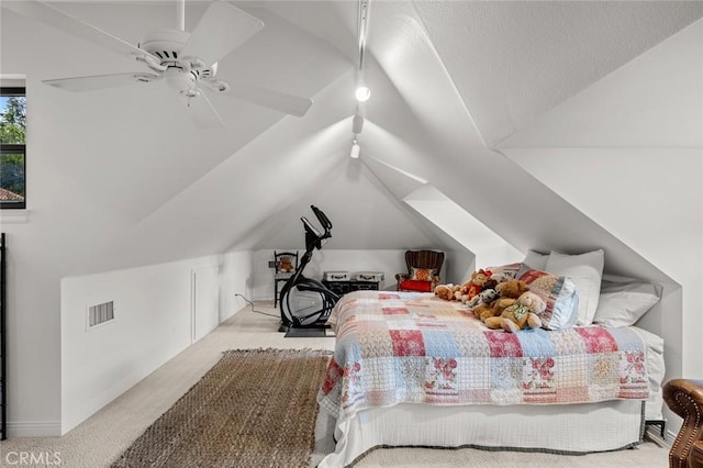 bedroom featuring ceiling fan, light colored carpet, and vaulted ceiling