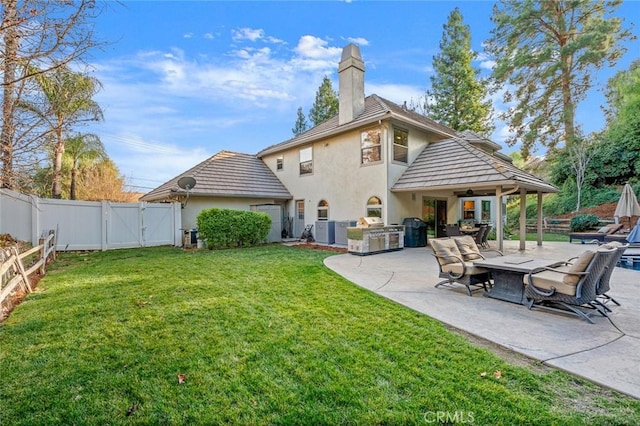 rear view of property with cooling unit, a yard, and a patio