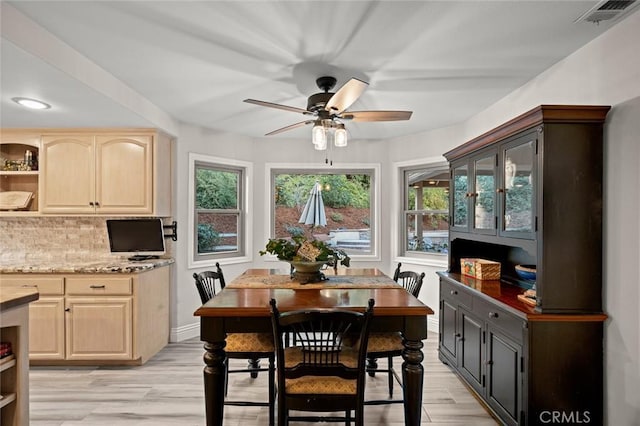 dining space with light hardwood / wood-style floors, ceiling fan, and a healthy amount of sunlight