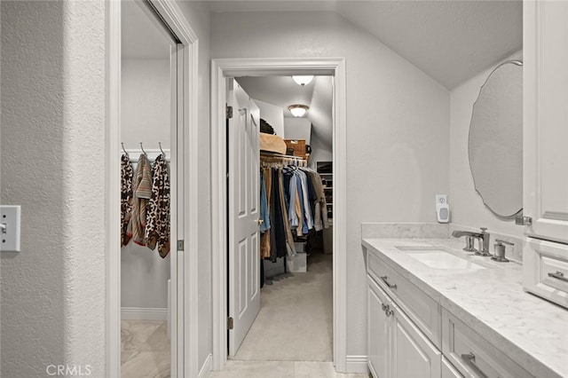 bathroom featuring vanity and lofted ceiling