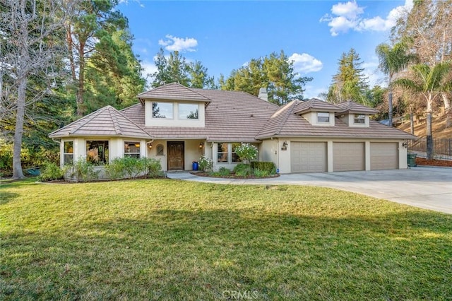 front facade with a garage and a front yard