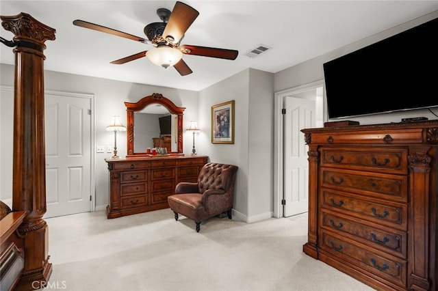 sitting room featuring light carpet, ceiling fan, and decorative columns