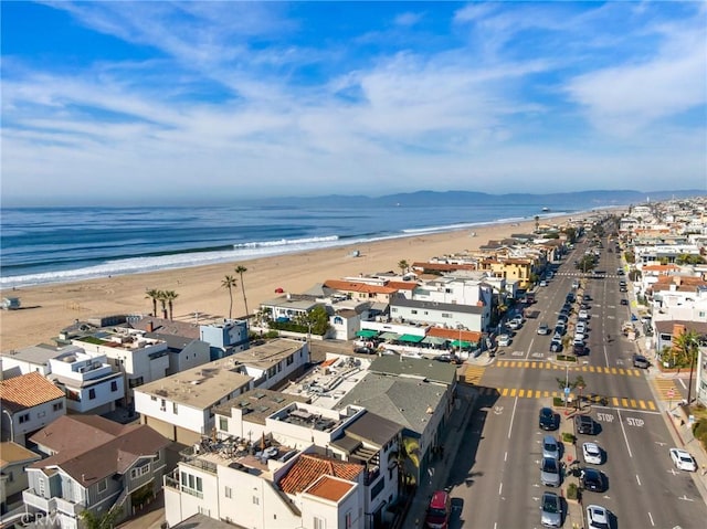 drone / aerial view with a beach view and a water view