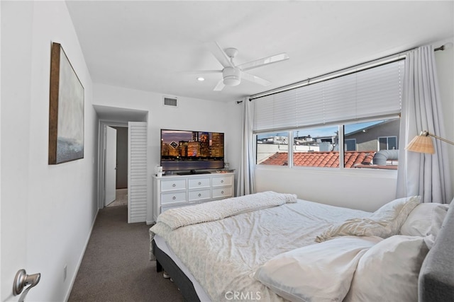 bedroom featuring ceiling fan and carpet