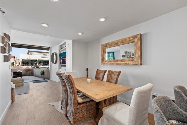 dining area with light hardwood / wood-style floors