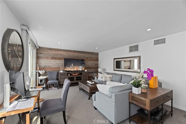 living room with wooden walls and carpet