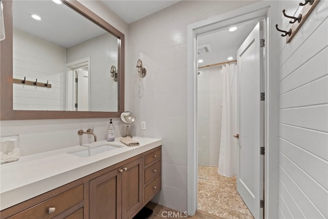 bathroom featuring vanity and curtained shower