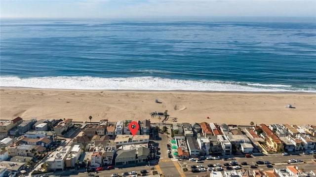 birds eye view of property featuring a view of the beach and a water view