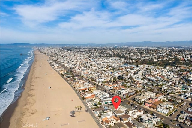 bird's eye view with a water view and a beach view