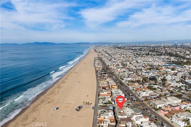 birds eye view of property with a water view and a view of the beach