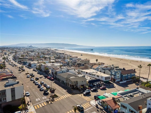 bird's eye view featuring a water view and a beach view