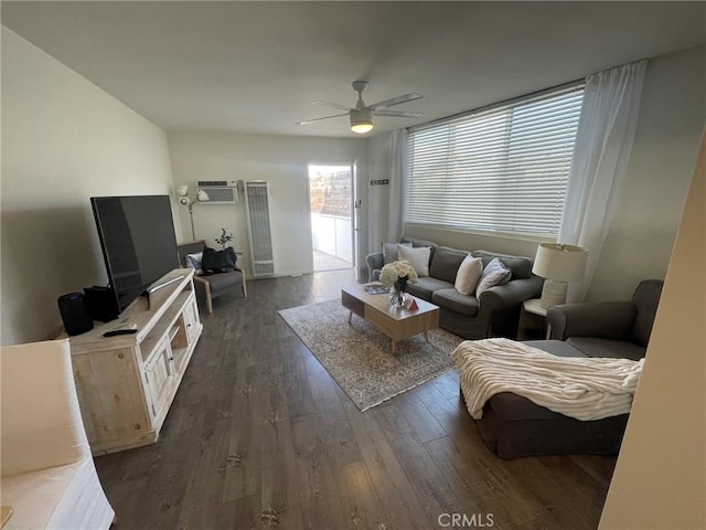 living room featuring dark hardwood / wood-style flooring, ceiling fan, and a wall mounted AC