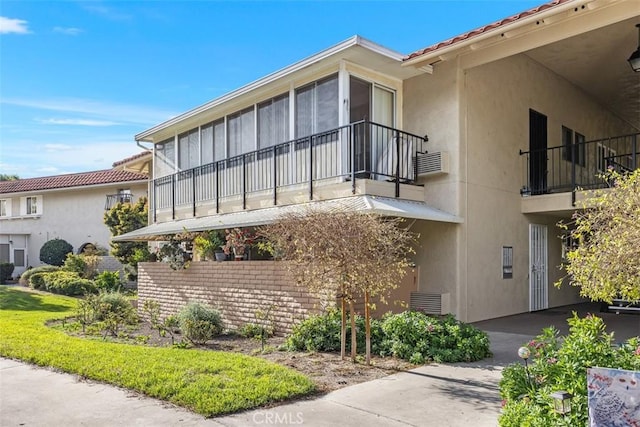 view of side of property with a balcony