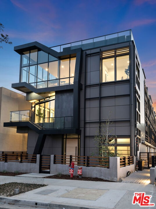 view of outdoor building at dusk