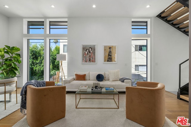 living room with a wealth of natural light and light hardwood / wood-style flooring