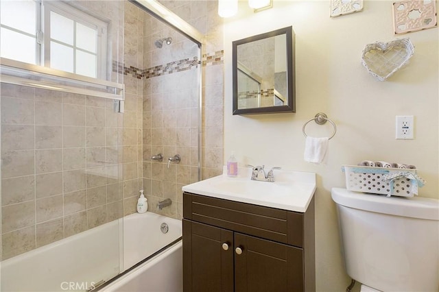 full bathroom with toilet, vanity, and bath / shower combo with glass door