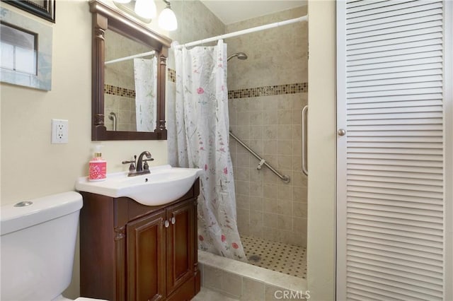 bathroom featuring curtained shower, toilet, and vanity