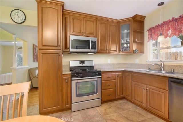 kitchen featuring a wealth of natural light, appliances with stainless steel finishes, sink, and pendant lighting