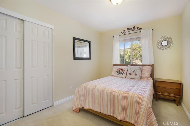 bedroom featuring light carpet and a closet