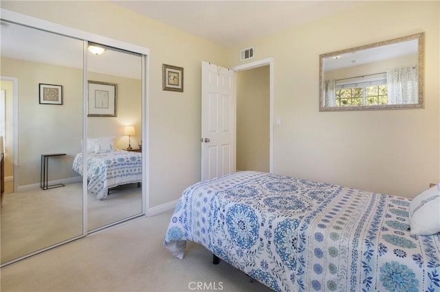 carpeted bedroom with a closet