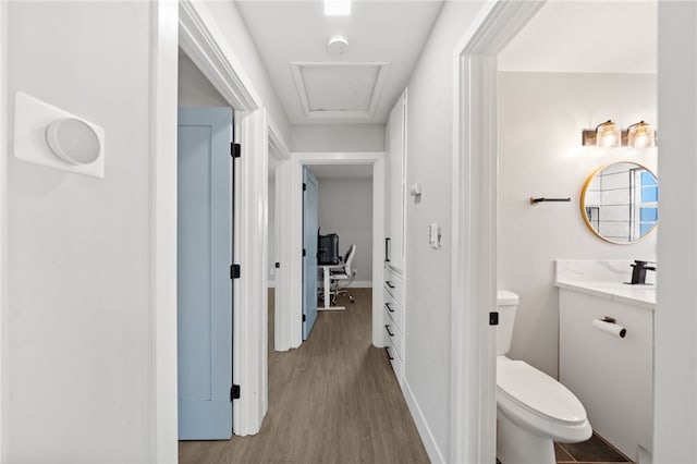 bathroom with toilet, vanity, and hardwood / wood-style floors