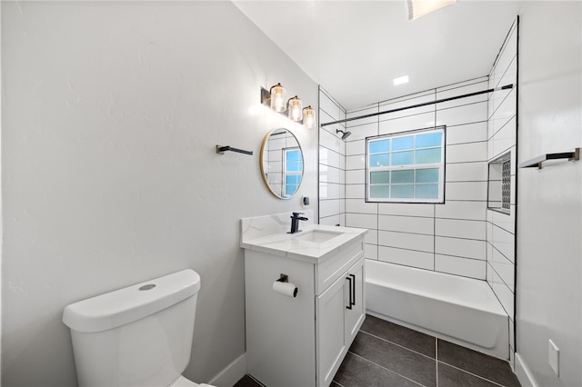 full bathroom with toilet, vanity, tiled shower / bath combo, and tile patterned floors