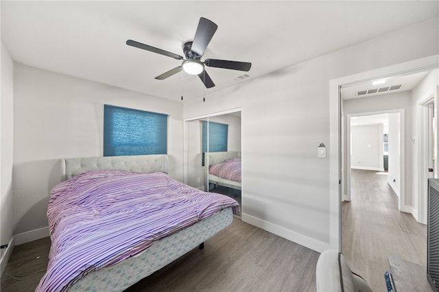 bedroom with ceiling fan and hardwood / wood-style flooring