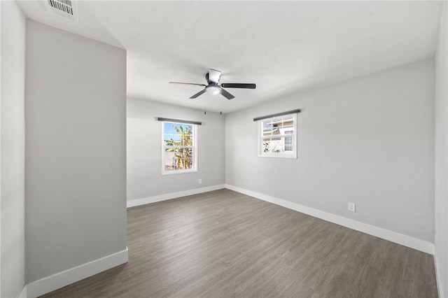 unfurnished room featuring ceiling fan and dark hardwood / wood-style flooring