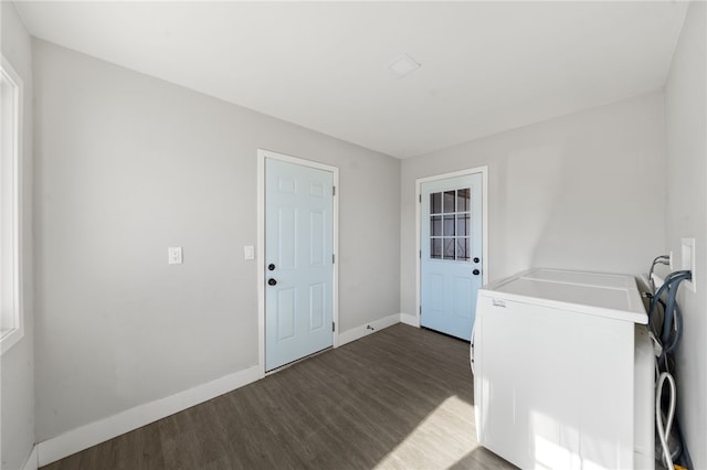 clothes washing area featuring washer and clothes dryer and dark hardwood / wood-style flooring