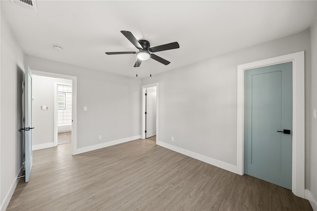 empty room featuring ceiling fan and light hardwood / wood-style flooring