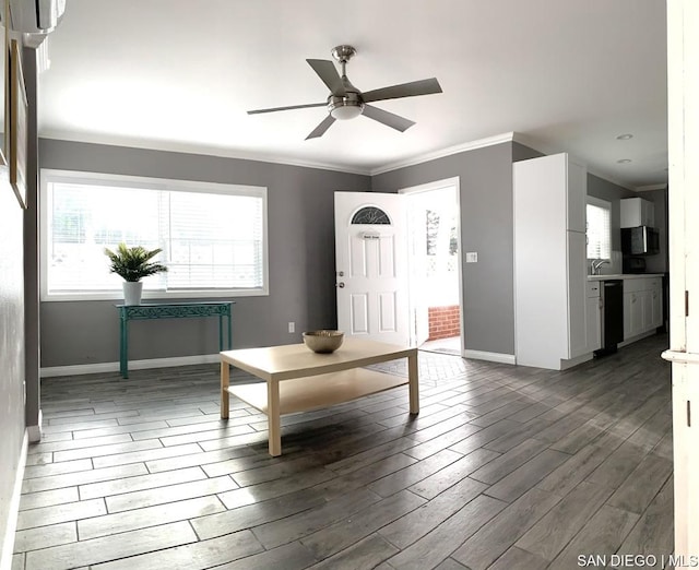 unfurnished living room featuring ceiling fan and ornamental molding