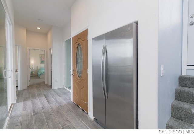 kitchen with hardwood / wood-style flooring and stainless steel refrigerator