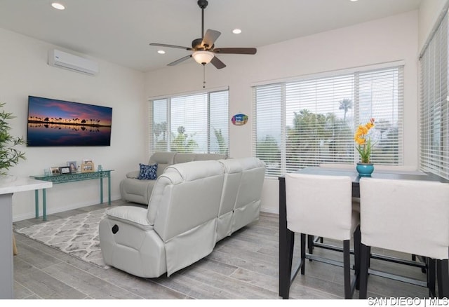 living room featuring ceiling fan and a wall mounted air conditioner