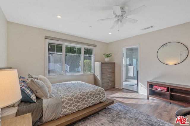 bedroom featuring ensuite bathroom, hardwood / wood-style floors, and ceiling fan