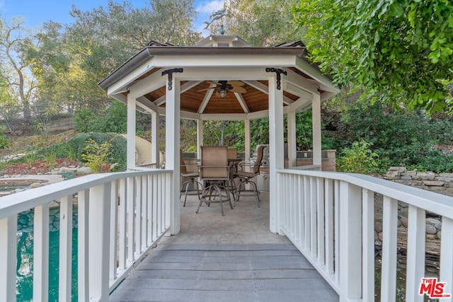 exterior space with a wooden deck and ceiling fan