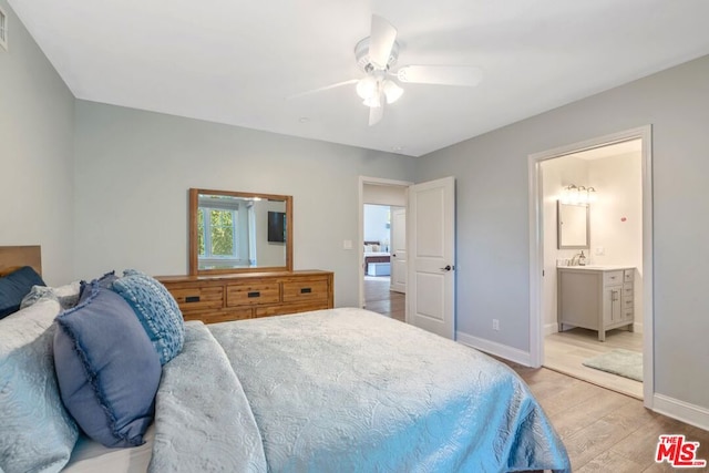 bedroom with ensuite bath, ceiling fan, and light wood-type flooring