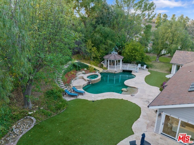 view of swimming pool featuring a gazebo, a yard, an in ground hot tub, and a patio area