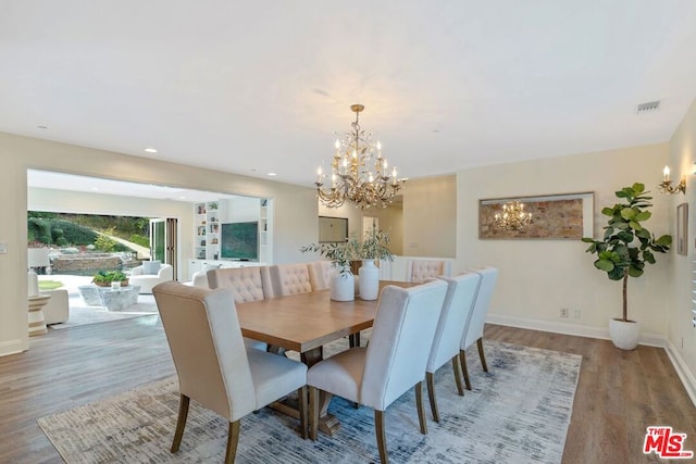 dining room featuring hardwood / wood-style flooring and a chandelier