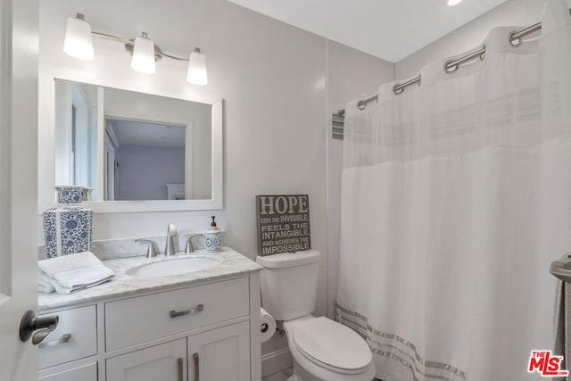 bathroom featuring vanity and toilet