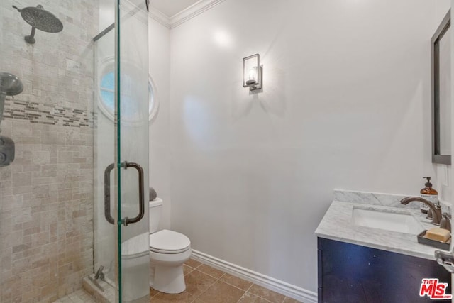 bathroom with tile patterned flooring, vanity, ornamental molding, a shower with shower door, and toilet