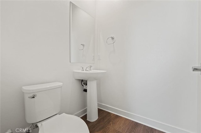 bathroom with wood-type flooring and toilet