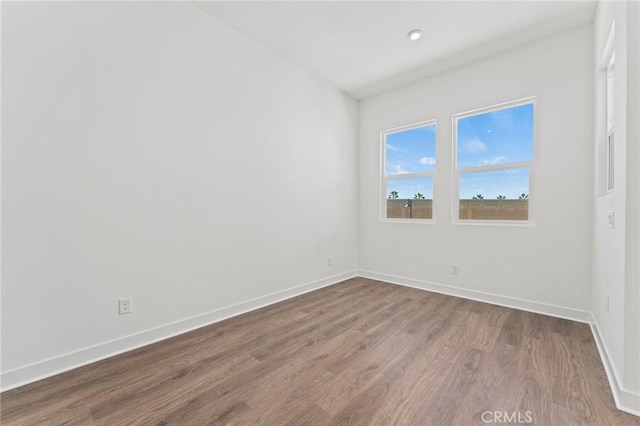 empty room with hardwood / wood-style floors