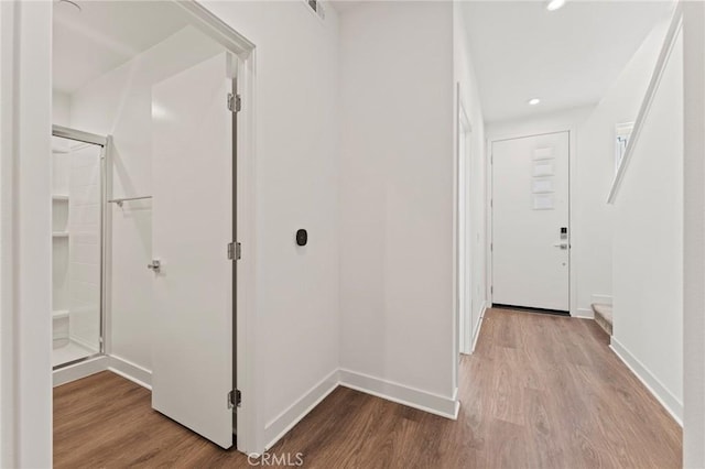 corridor with light hardwood / wood-style floors