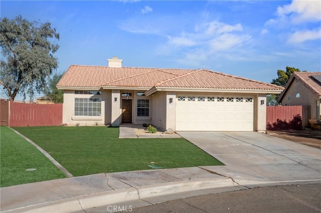 view of front of home with a garage and a front lawn