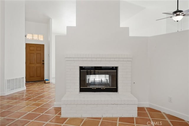 interior details with ceiling fan and a fireplace