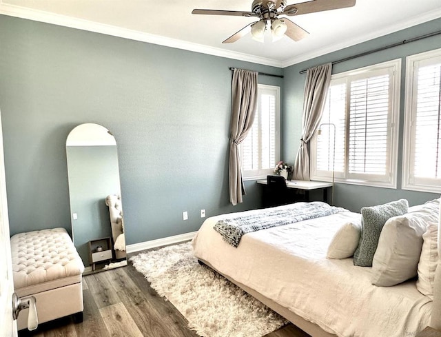 bedroom featuring ceiling fan, dark hardwood / wood-style flooring, and crown molding